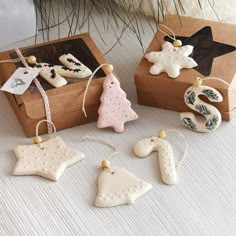 some ornaments are sitting on a table next to a box with tags and other decorations