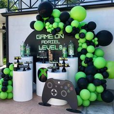 a video game themed party with black and green balloons