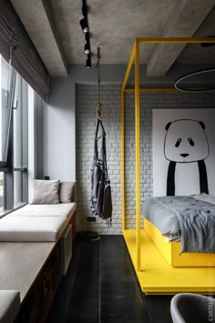 a bed room with a neatly made bed next to a wall mounted panda print on the wall