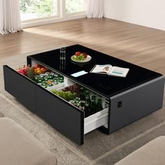 a coffee table with an open drawer underneath it on a carpeted floor in front of a window