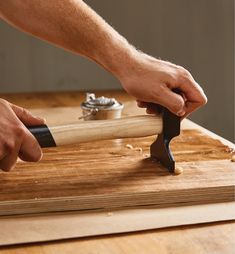 a person using a hammer to cut wood