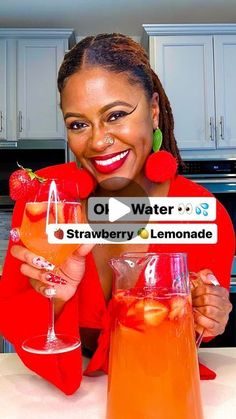 a woman is holding up two pitchers of lemonade