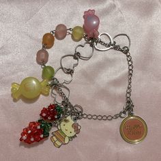 a bunch of charms that are sitting on a bed together with one charm attached to the other