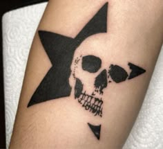 a skull and star tattoo on the arm