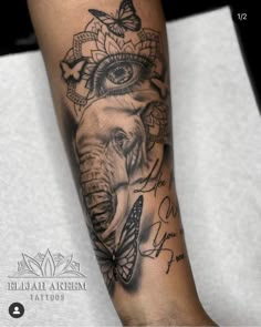 an elephant and butterfly tattoo on the arm