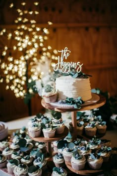 a table topped with cupcakes and cakes covered in frosting