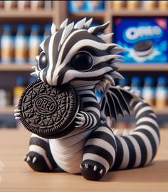 a zebra figurine with an oreo cookie in it's mouth