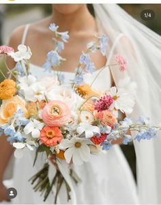 a bride holding a bouquet of flowers in her hands