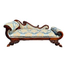 an ornately decorated chaise lounge chair with blue and white fabric on it's back