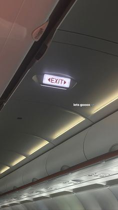 the exit sign on an airplane is lit up