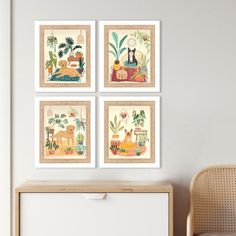 four framed pictures hang on the wall above a dresser in a room with a wicker chair