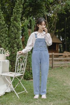 Classic denim overalls with floral embroidery around the bib, roomy side pockets, back pockets, button up sides and tapered legs. S: 32" waist, 40" hips, 12" rise, 23.5" thighs, 17" ankles, 23" inseamM: 33.5" waist, 41.5" hips, 12" rise, 24.5" thighs, 17.5" ankles, 23" inseamL: 35" waist, 43" hips, 12" rise, 25.5" thighs, 18" ankles, 23" inseam How to attach buckles:Slide the rectangular buckle on first, followed by the T-shaped buckle. Overall straps will hold on its own as such or you can slide the free end back into the rectangular buckle. Embroidered Denim, Denim Overalls, Overall Dress, Retro Floral, Sweater Blouse, Cardigan Jacket, Medium Blue, Tapered Legs, Floral Embroidery