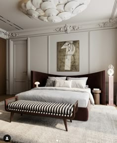 a bedroom with a large bed and white walls