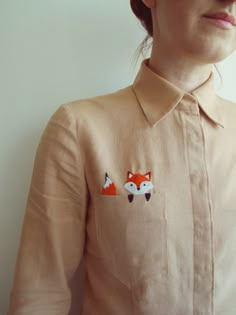 an image of a woman wearing a shirt with fox appliques on the front