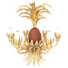 a pineapple chandelier with five glasses on it's bottom and four arms