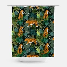 a shower curtain with tigers and tropical leaves on the outside, along with an orange tiger in the middle