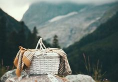 a wicker basket sitting on top of a rock