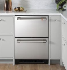 a stainless steel dishwasher in a white kitchen