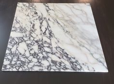 a marbled table top on a wooden surface