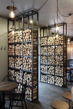 the interior of a restaurant with tables, chairs and shelves filled with wood planks