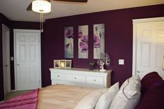 a bedroom with purple walls and white furniture