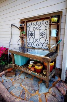 an outdoor sink with pots and pans on it