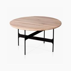 an oval table with black metal legs and a wooden top, on a white background