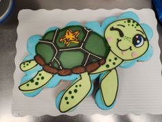 a decorated turtle cake sitting on top of a white plate