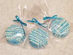 three blue and white cookies wrapped in plastic