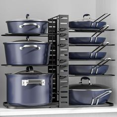 pots and pans are stacked on the shelf