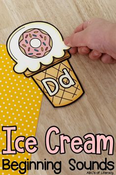 an ice cream poster with the words ice cream beginning sounds in front of it and a hand holding up a doughnut