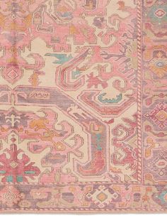 an antique rug with pink and blue colors