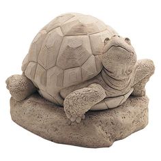 a turtle statue sitting on top of a rock