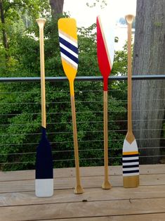 three wooden paddles sitting on top of a wooden deck