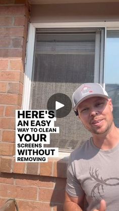 a man giving the thumbs up while standing in front of a brick building with a sign that says here's an easy way to clean your screens without removing