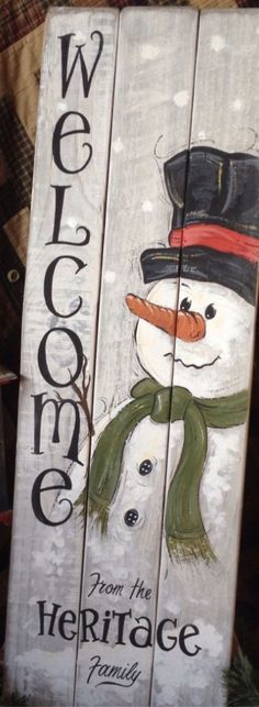 a wooden sign with a snowman on it that says welcome to the heritage family