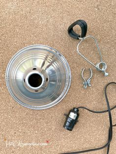 an overhead view of a metal object on the ground with earphones attached to it