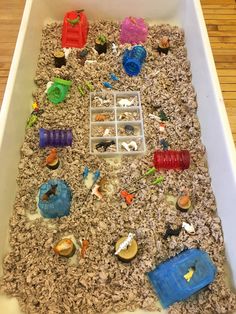 an indoor sandbox filled with toys and other things to play with in the sand