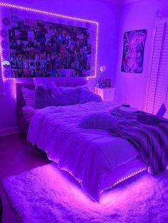 a bedroom with purple lighting and pictures on the wall above the bed is lit up