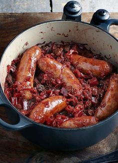 there are many sausages in the pot on the table