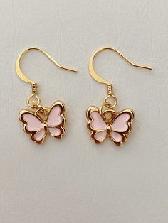 handmade dangle earrings with a light pink butterfly charm and gold findings Light Pink Butterfly, Butterfly Dangle Earrings, Handmade Dangle Earrings, Butterfly Earrings Gold, Kris Kringle, Earrings Handmade Dangle, Girly Accessories, Jewelry Essentials