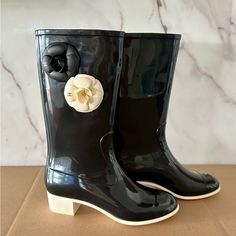 Chanel Camelia Rain Boots Featuring A Sleek Black Design Adorned With Beautiful Cream And Black Coco Chanel Flowers, These Boots Are Perfect For Both Rainy Days And Chic Outings. Condition: Gently Used - See Photos For Details. Size: 38 Color: Black With Cream And Black Floral Accents Included: Boots Only These Boots Combine Luxury And Practicality, Making Them A Must-Have Addition To Your Wardrobe. Don’t Miss Out On This Iconic Pair! Feel Free To Reach Out With Any Questions Or For Additional P Chanel Rubber Boots, Chanel Rainboots, Chanel Glitter Boots, Chanel Boots Farfetch, Black Ankle-high Waterproof Rain Boots, Shoes Chanel, Chanel Black, Winter Rain, Chanel Shoes