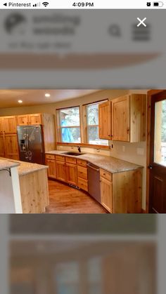 an image of a kitchen with wood cabinets and stainless steel appliances in the middle of it