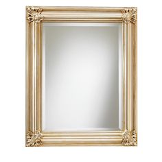 a gold framed mirror on a white wall