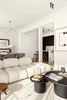 a living room filled with lots of white furniture