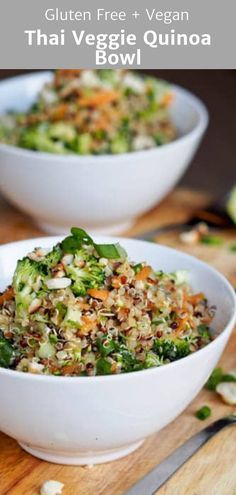 two white bowls filled with vegetables on top of a wooden table