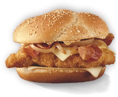 a chicken sandwich with cheese and bacon on a white background is seen in this image