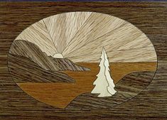 a wooden plaque with trees and mountains in the background on a wood paneled surface