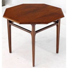 a wooden table with two legs and a hexagonal shape on the top, sitting against a white background