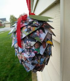 an ornament hanging from the side of a house with photos attached to it